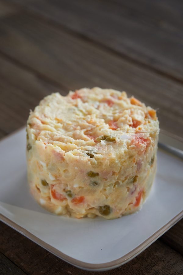 Typical spanish tapa called Russian salad or ensaladilla rusa. Potato salad with tuna and mayonnaise . Close up view, selective focus.